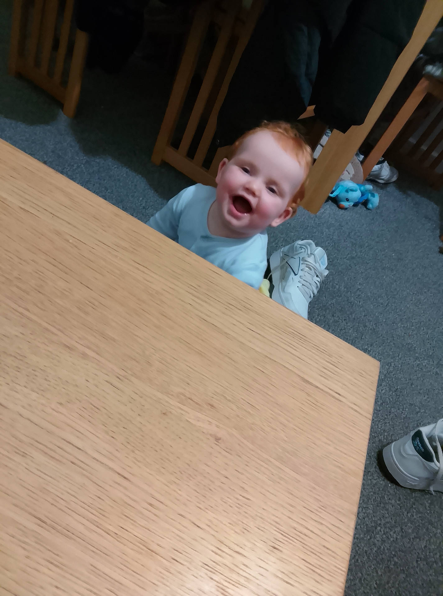 baby, carpet, chair, child, cute, expression, floor, furniture, happy, home, indoor, person, playful, red_hair, smiling, sneakers, table, toddler, toy, wooden_table