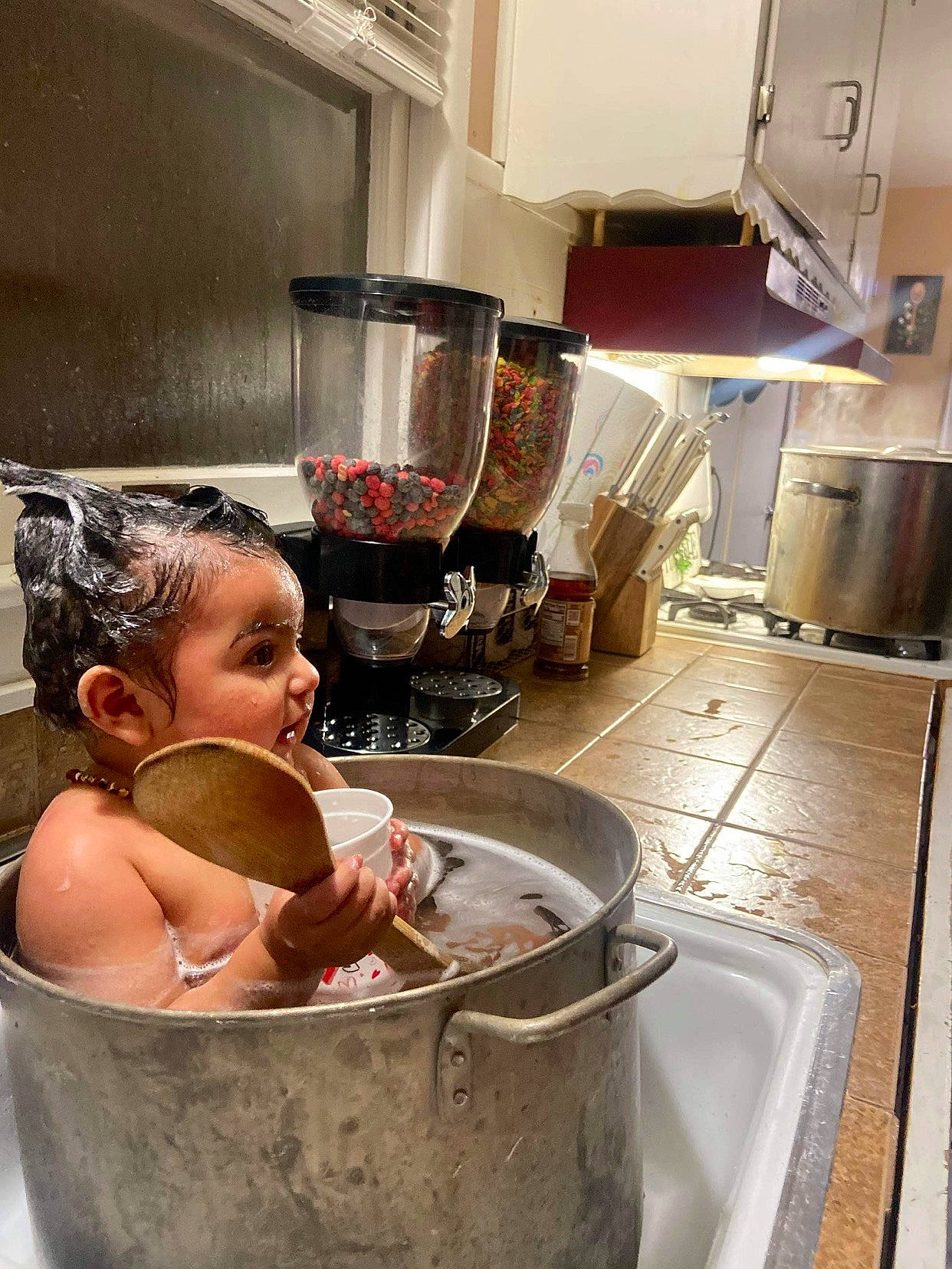Sienna is registered to the contest to win money with this photo: aluminium, baby, bathing, bowl, cooking, cookware_and_bakeware, flesh, gas, homemaker, kitchen, kitchen_appliance, metal, mixer, mixing_bowl, person, recipe, room, serveware, stock_pot, toddler