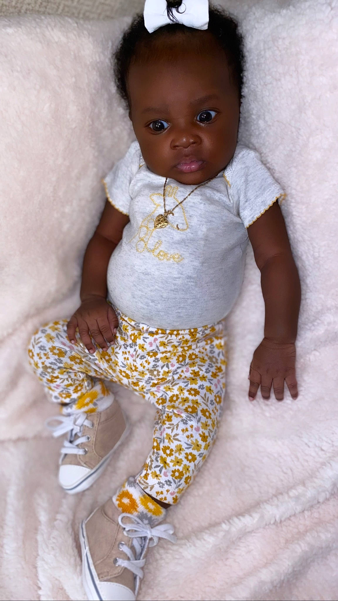 Tiahna Elisè is registered to the contest to win money with this photo: arm, baby, baby_toddler_clothing, cheek, child, comfort, hand, happy, one_piece_garment, pajamas, pattern, person, sitting, skin, sleeve, sportswear, t_shirt, textile, thigh, toddler