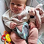 baby, infant, smiling, cute, cushion, baby_seat, soft_toy, rattle, clothing, pink_pants, white_sweater, face, hand, foot, indoors, child, happy, portrait, cozy, cute_expression