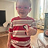 Jaxon joined the competition — help win amazing prizes! child, toddler, boy, glasses, heart_shaped_glasses, striped_shirt, red_clothing, toy, indoor, living_room, furniture, wooden_floor, window, curtains, smiling, happy, person, home, playful, cute