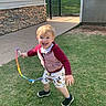 child, toddler, playing, outdoor, grass, ribbon, happy, smiling, sunlight, casual_clothing, shorts, jacket, barefoot, fun, daytime, two_children, lawn, running, joy, playtime