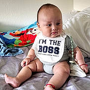 Felix Yang joined the competition — help win amazing prizes! baby, infant, child, sitting, bib, clothing, bed, blanket, toy, indoors, cute, chubby, expression, person, playful, colorful, smile, head, skin, young