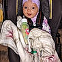 baby, cap, car, car_interior, carseat, clothing, coat, couch, cushion, face, furniture, hat, head, homedecor, jacket, person, photography, portrait, transportation, vehicle