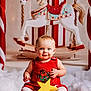 baby, child, red_dress, yellow_star, rocking_horse, holiday, christmas, festive, toy, carpet, smiling, blue_eyes, white_tights, indoor, portrait, cute, decor, background, holiday_theme, seasonal