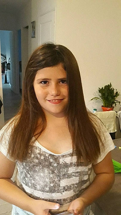 Abby participe au concours pour gagner de l'argent avec cette photo : black_hair, brown_hair, chair, cheek, chest, child, event, eyelash, hair_coloring, happy, houseplant, jewellery, joy, layered_hair, long_hair, makeover, person, plant, sitting, smile