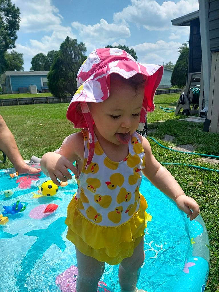 Luna is registered to the contest to win money with this photo: baby_toddler_clothing, baseball_cap, cap, child, cloud, fun, grass, happy, hat, headwear, leisure, person, photograph, pink, plant, recreation, sky, smile, summer, toddler