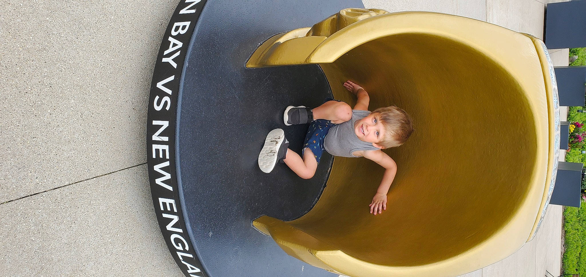 James is registered to the contest to win money with this photo: arm, automotive_tire, automotive_wheel_system, brand, circle, comfort, font, fun, happy, human_body, leisure, logo, person, recreation, sleeve, t_shirt, toddler