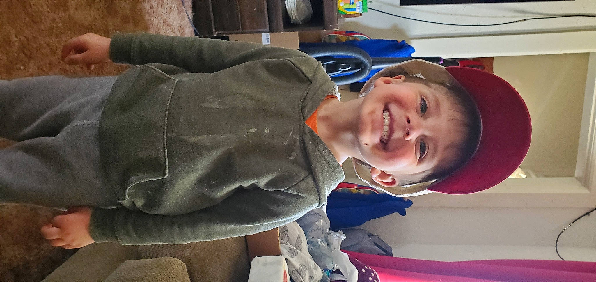 Harry is registered to the contest to win money with this photo: baby, child, comfort, electric_blue, event, fun, happy, joy, laugh, mouth, person, personal_protective_equipment, room, sitting, smile, toddler