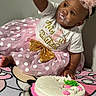 baby, child, birthday, cake, frosting, pink, tutu, dress, headband, celebration, party, sitting, cute, happy, one_year_old, polka_dot, jewelry, necklace, hand, floor