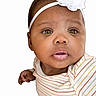 Sahara Jean is registered to the contest to win money with this photo: adorable, baby, child, closeup, clothing, cute, expression, eyes, face, flower, headband, infant, looking, mouth, person, portrait, skin, striped_shirt, white_background, young