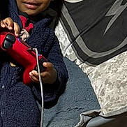 Tiny joined the competition — help win amazing prizes! child, game_controller, chair, blanket, indoor, cozy, smiling, casual, young, person, furniture, playful, relaxed, clothing, home, portrait, candid, comfortable, holding, seated