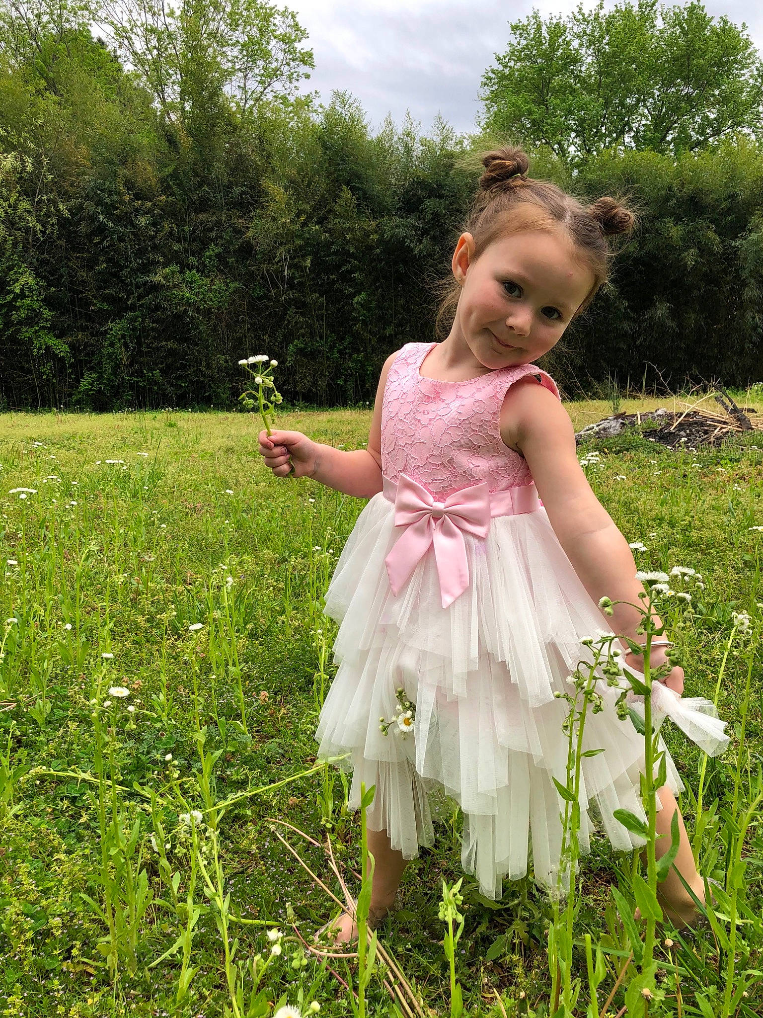 Remi joined the competition — help win amazing prizes! baby_toddler_clothing, blond, day_dress, dress, flower, gown, grass, grassland, happy, lawn, meadow, one_piece_garment, people_in_nature, person, petal, plant, prairie, sky, terrestrial_plant, toddler