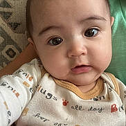 David joined the competition — help win amazing prizes! baby, infant, face, eyes, clothing, onesie, pattern, paw_prints, cute, portrait, child, young, sitting, indoors, expression, skin, head, person, closeup, comfort