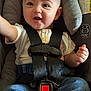 David joined the competition — help win amazing prizes! baby, car_seat, child, smile, happy, safety_harness, clothing, suspenders, jeans, infant, cute, seat_belt, straps, portrait, indoors, person, face, hand, cushion, graco