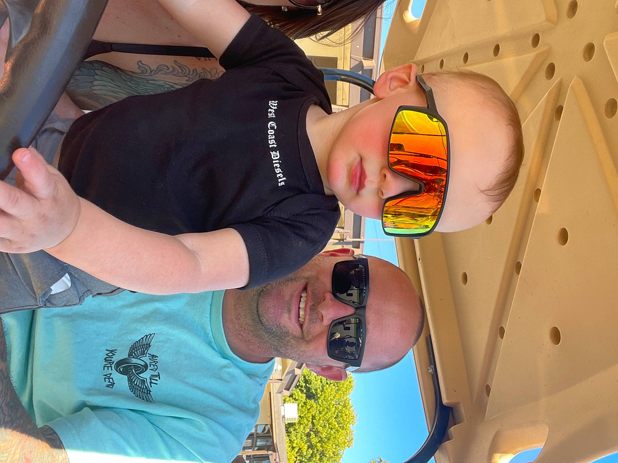 Jaxon is registered to the contest to win money with this photo: child, elbow, eyewear, finger, fun, gesture, happy, joy, leisure, mouth, organ, person, photograph, sky, snapshot, sunglasses, t_shirt, tableware, thumb, vacation