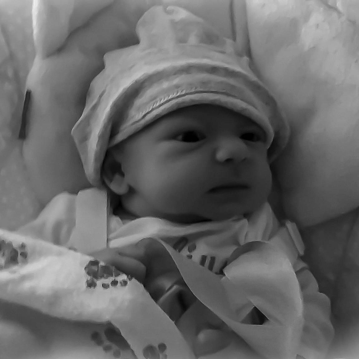 Safiya is registered to the contest to win money with this photo: baby, birth, black_and_white, cheek, child, eye, finger, hand, headwear, lip, monochrome, monochrome_photography, mouth, person, photograph, photography, skin, smile, style, toddler