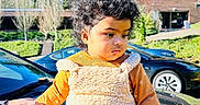 Anika Yenkarla is registered to the contest to win money with this photo: baby, black_car, building, car, child, curly_hair, cute, daytime, fall_clothing, fuzzy_overalls, greenery, holding_hand, outdoor, person, portrait, reflection, socks, sunny_day, toddler, trees