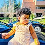 toddler, child, baby, outdoor, car, holding_hand, fuzzy_overalls, socks, curly_hair, sunny_day, building, trees, greenery, black_car, reflection, person, portrait, cute, fall_clothing, daytime
