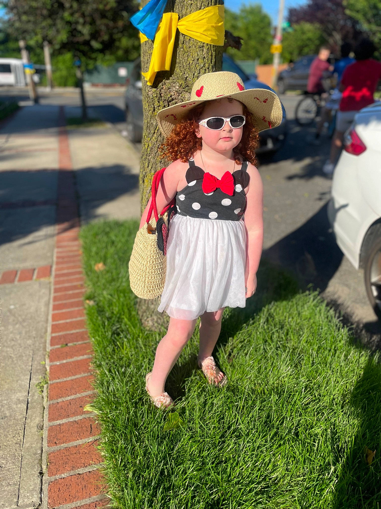 Teegan joined the competition — help win amazing prizes! eyewear, fawn, fedora, glasses, goggles, grass, green, hat, leaf, person, plant, public_space, street_fashion, sun_hat, sunglasses, toy, tree, vision_care, waist, wheel