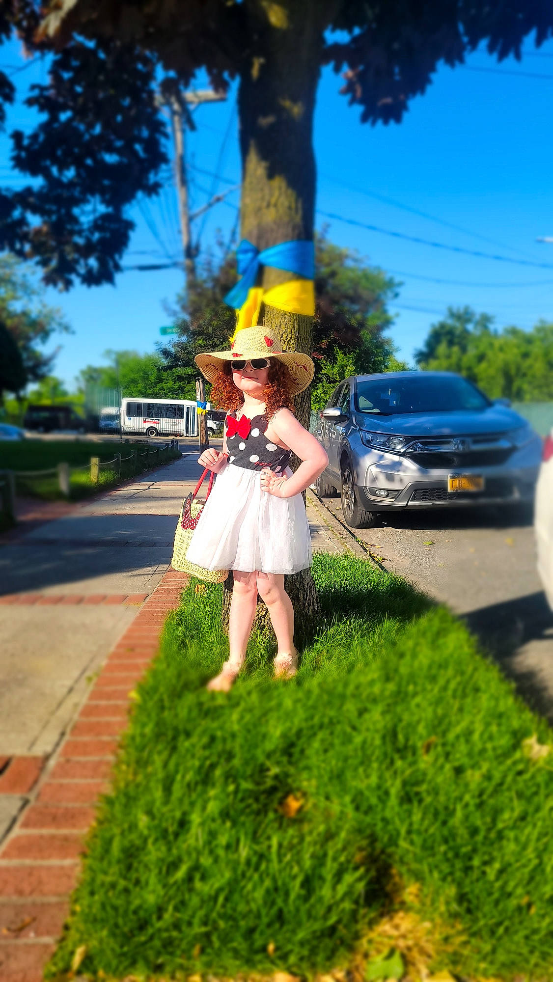 Teegan is registered to the contest to win money with this photo: asphalt, cap, car, electric_blue, fun, grass, happy, hat, landscape, leisure, person, plant, recreation, road, sidewalk, sky, street_fashion, summer, sun_hat, tree