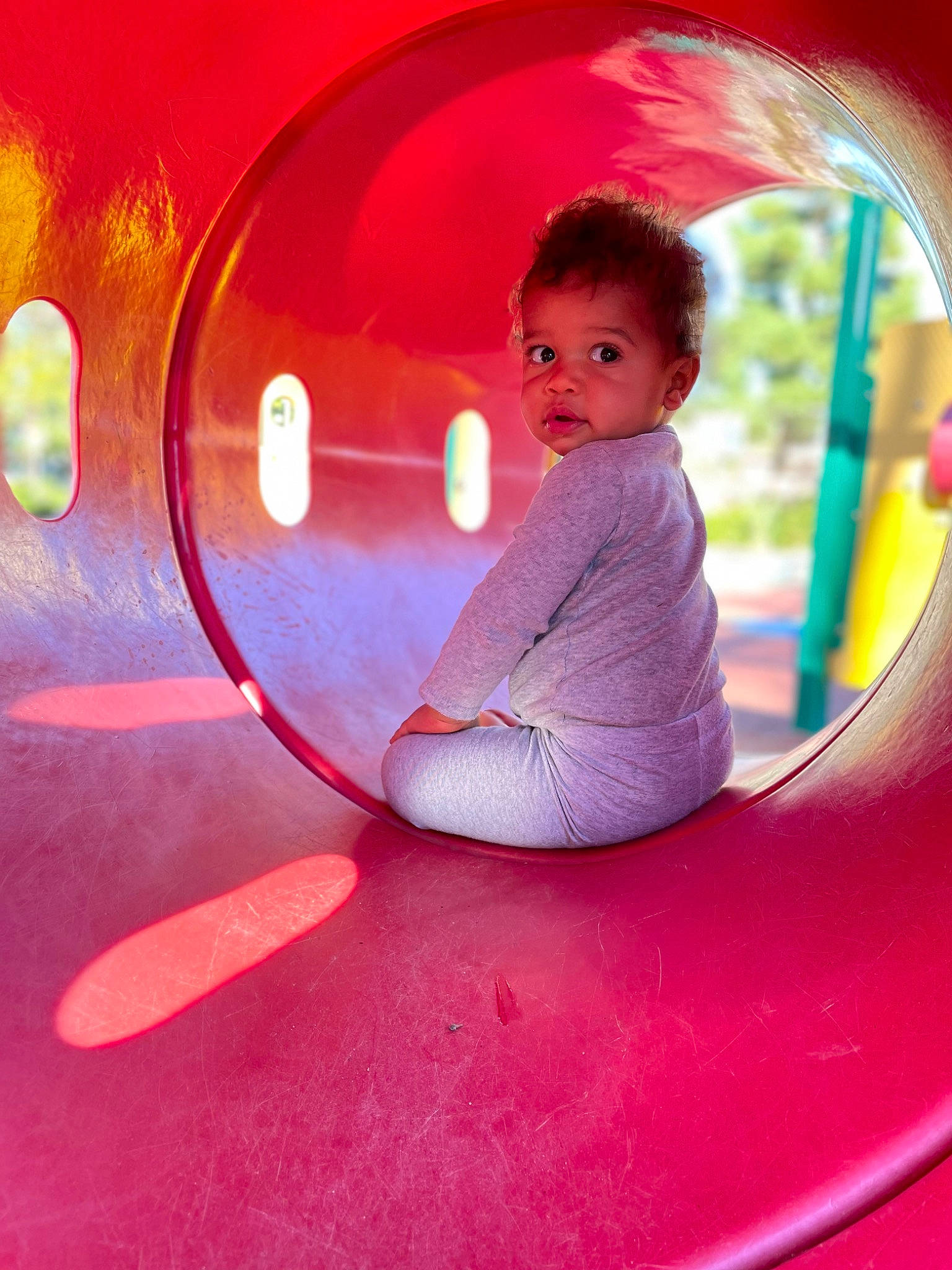 Carmelo is registered to the contest to win money with this photo: auto_part, automotive_wheel_system, baby_toddler_clothing, child, circle, electric_blue, event, facial_expression, flash_photography, fun, happy, leisure, magenta, person, pink, playground, purple, recreation, sitting, toddler