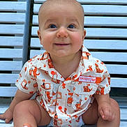 Ryder joined the competition — help win amazing prizes! baby, child, smiling, shirt, orange, white, bench, wooden_bench, foot, hand, sitting, cute, patterned_shirt, happy, outdoor, portrait, infant, face, eyes, hair