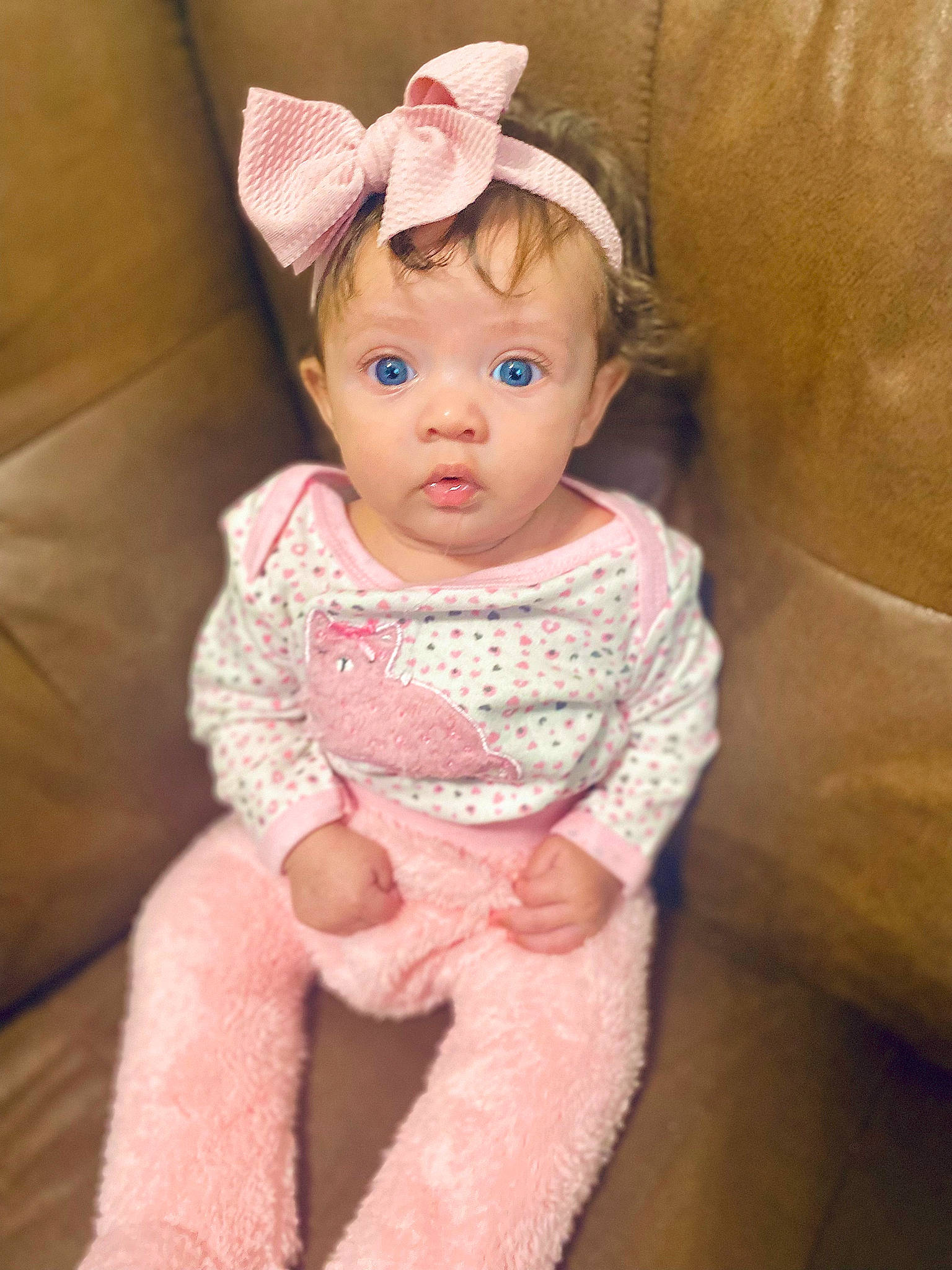 Lillianna is registered to the contest to win money with this photo: arm, baby, baby_toddler_clothing, cheek, child, dress, embellishment, eye, face, headgear, human_body, iris, lip, magenta, neck, person, pink, skin, sleeve, surprise