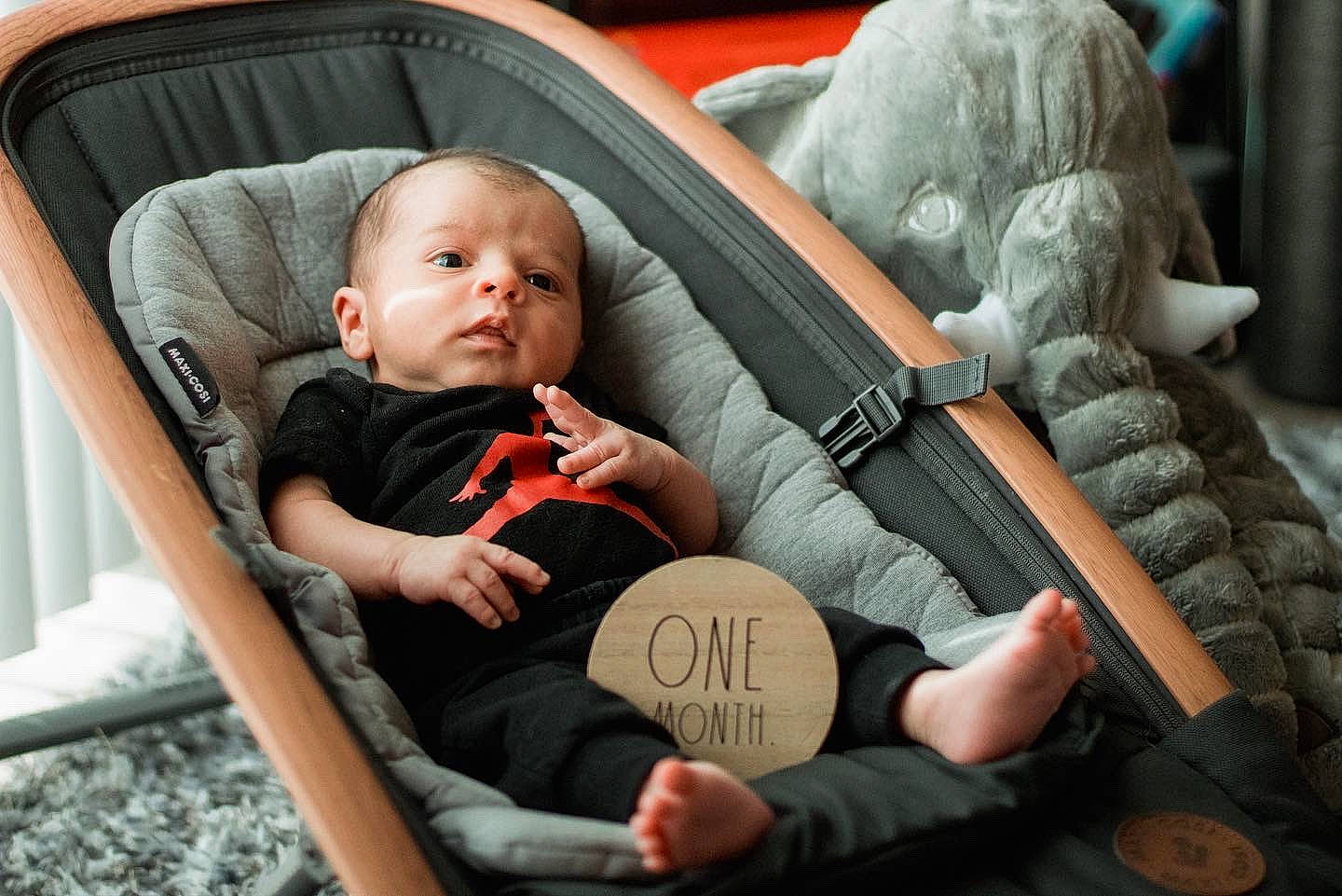 Giovanni Elijah is registered to the contest to win money with this photo: arm, baby, baby_carriage, baby_toddler_clothing, chair, cheek, comfort, fashion, fun, hairstyle, hand, head, human, interaction, mammal, mouth, person, skin, toddler, tree