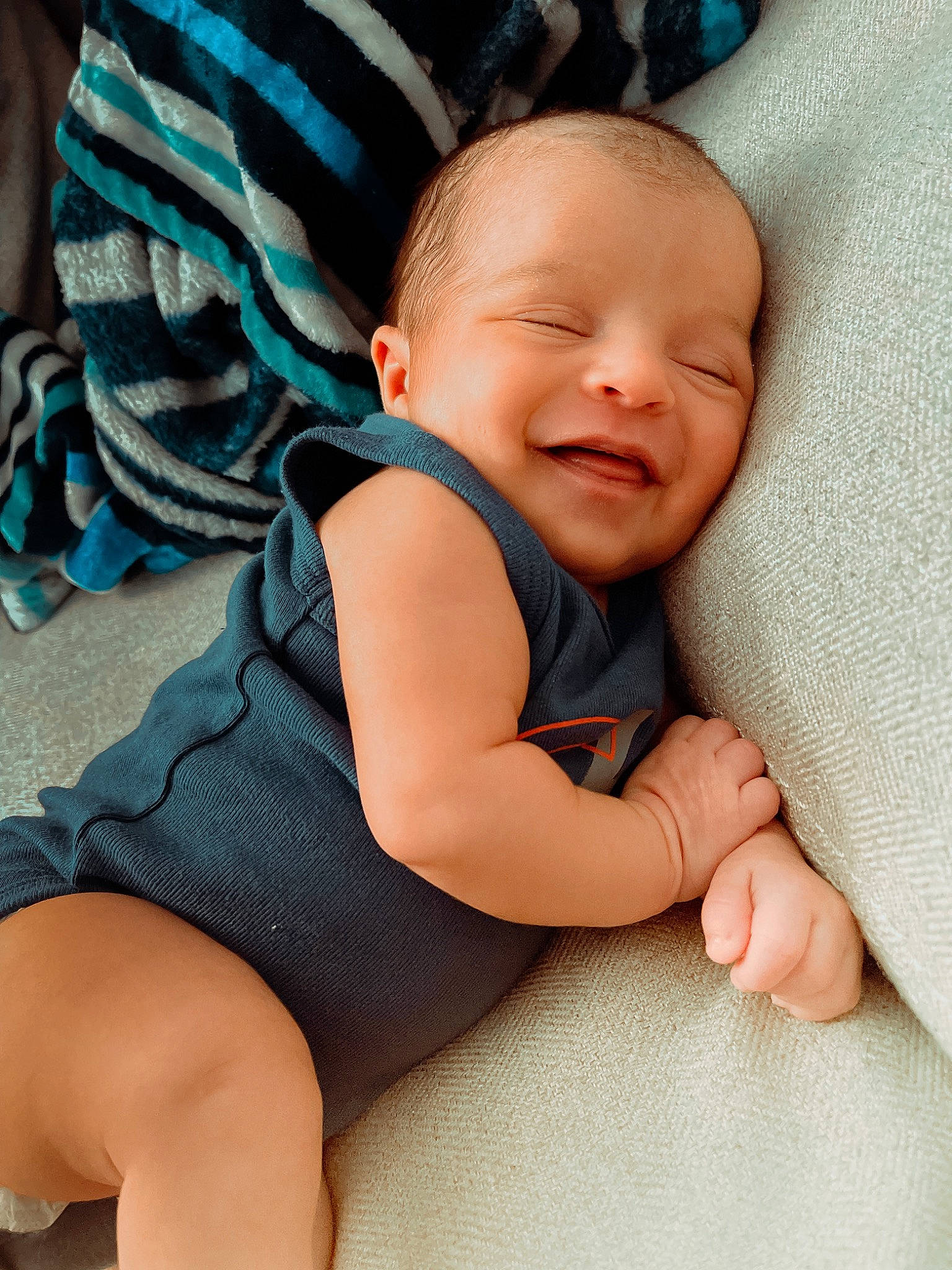 Giovanni Elijah is registered to the contest to win money with this photo: azure, baby, baby_toddler_clothing, blue, cheek, comfort, eye, finger, hand, happy, human_body, iris, joint, leg, person, skin, smile, textile, thigh, thumb