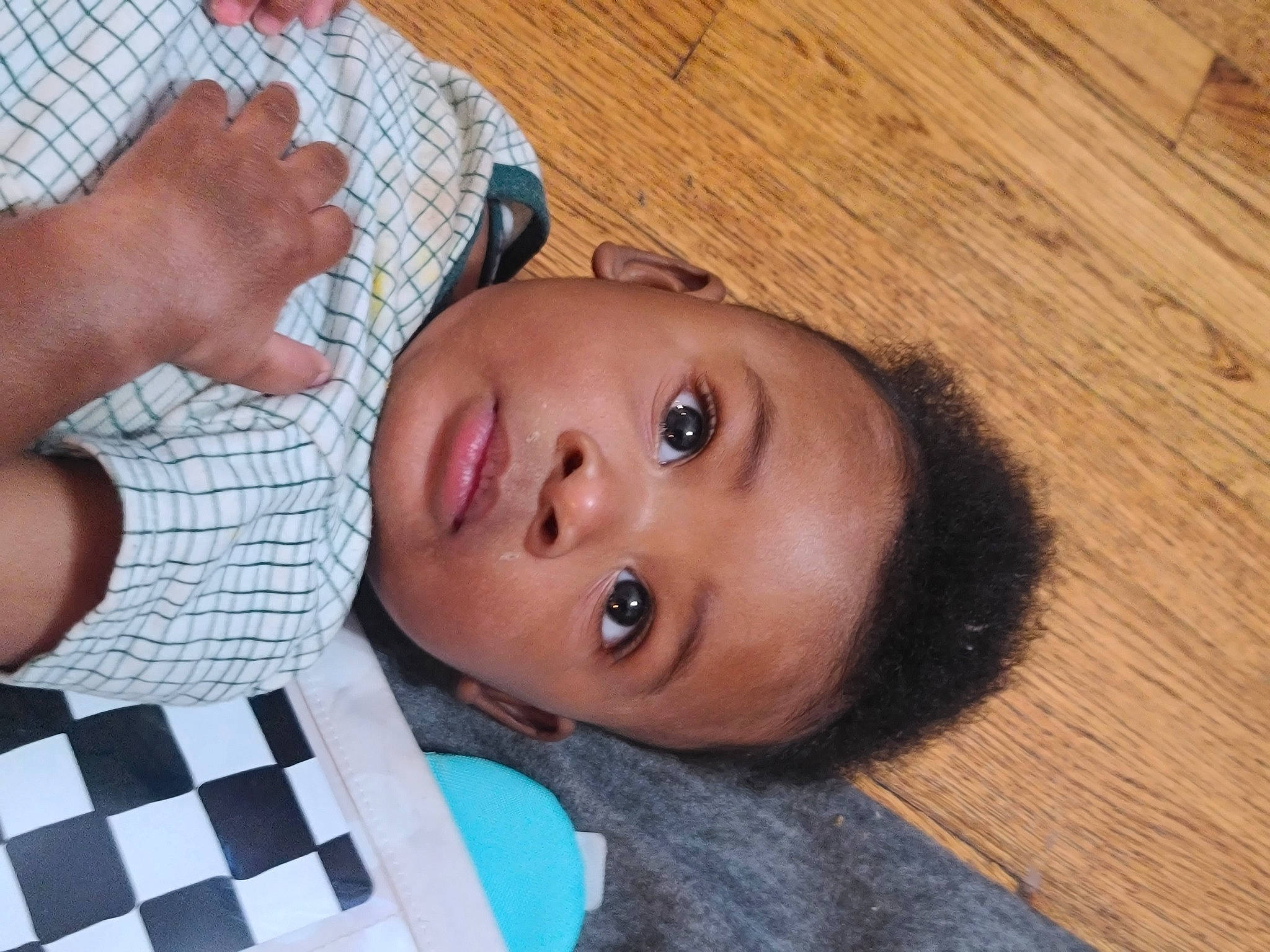 Kamren joined the competition — help win amazing prizes! baby, cheek, child, eyelash, finger, flooring, fun, gesture, happy, hardwood, iris, lip, mouth, nail, nose, pattern, person, thumb, toddler, wood