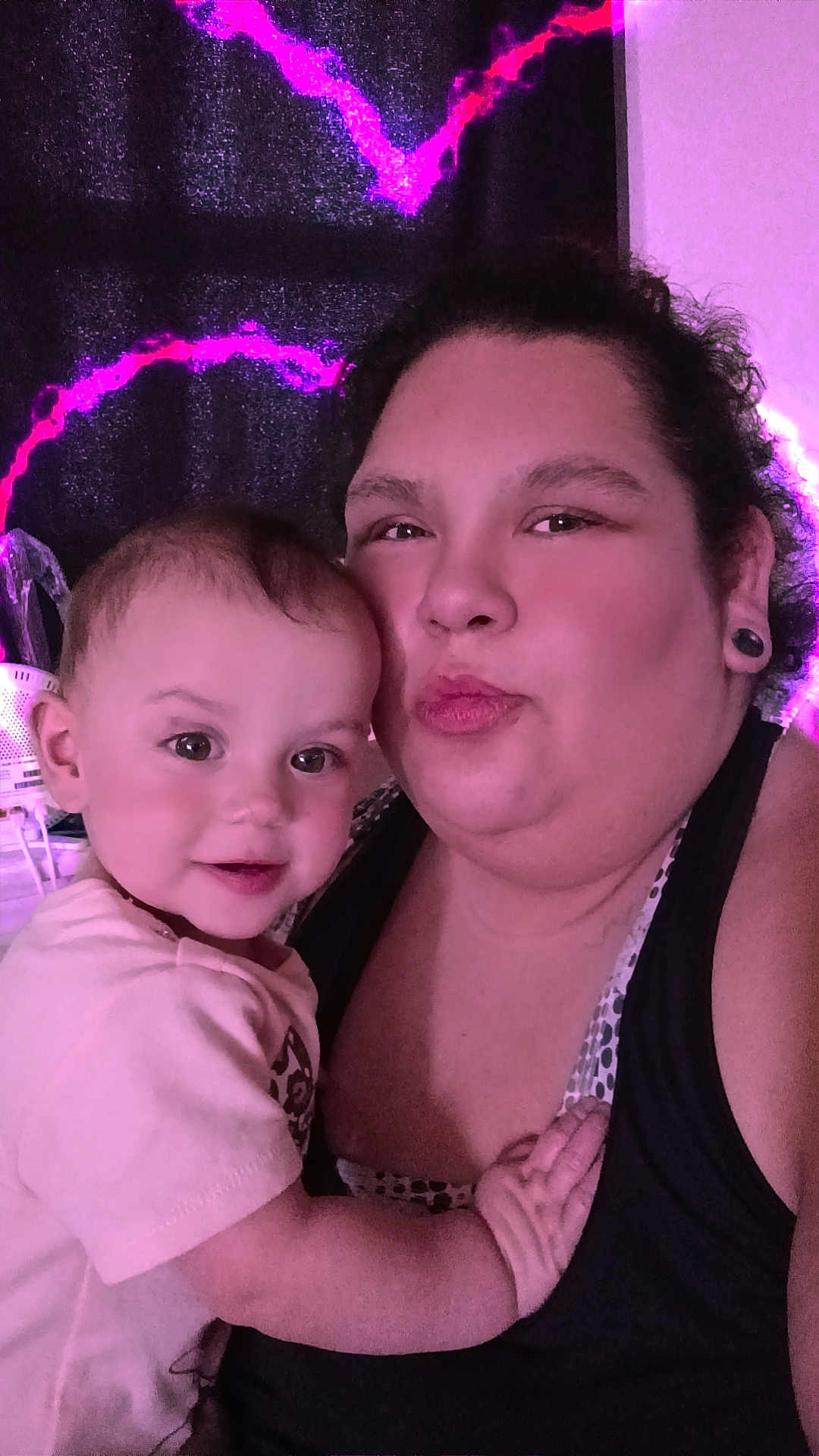 Aurora joined the competition — help win amazing prizes! child, baby, adult, woman, selfie, portrait, smile, indoor, curtain, neon_light, purple_tint, holding, hug, family, face, eyes, tank_top, ear_gauge, short_hair, skin