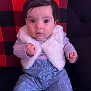 Aliyana joined the competition — help win amazing prizes! baby, black, bow, child, clothing, couch, cute, expression, eyes, face, hair, indoors, infant, pants, pattern, pillow, portrait, red, sitting, vest