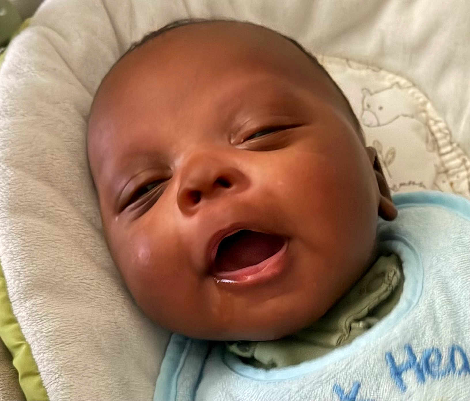 Ayden is registered to the contest to win money with this photo: baby, closeup, drool, yawning, infant, face, cushion, soft, comfort, sleepy, clothing, bib, portrait, newborn, skin, head, expression, cute, child, resting