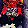 baby, child, car_seat, red_clothing, headband, leopard_print, white_shoes, black_pants, infant, cute, smile, sitting, indoors, clothing, person, baby_accessories, seatbelt, face, young_child, portrait