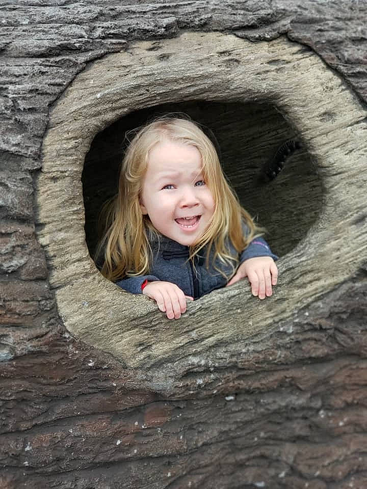 Adasyn is registered to the contest to win money with this photo: child, eye, fun, joy, person, photograph, photography, portrait, skin, smile, stone_wall, tree, trunk, wood