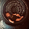 baby, infant, tire, wheel, black_rhino, clothing, camouflage, newborn, posing, indoors, cute, small, black, round, rubber, vehicle_part, stacked, baby_boy, portrait, resting