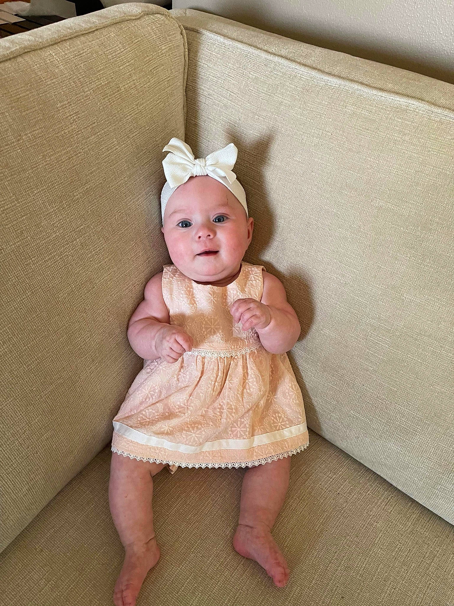 Gabriela joined the competition — help win amazing prizes! baby, baby_toddler_clothing, child, comfort, day_dress, dress, embellishment, fashion_accessory, foot, headband, headpiece, headwear, linens, one_piece_garment, pattern, peach, person, sitting, sleeve, textile