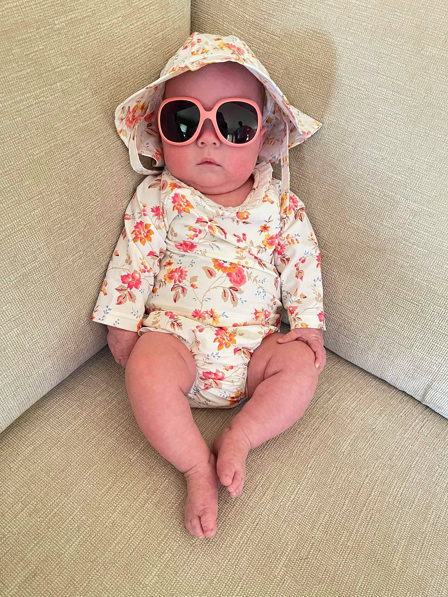 Gabriela is registered to the contest to win money with this photo: baby, baby_toddler_clothing, chin, collar, comfort, eyewear, face, glasses, goggles, hand, happy, head, lip, pattern, person, skin, sleeve, sunglasses, textile, toddler