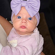Violet joined the competition — help win amazing prizes! baby, infant, child, face, blue_eyes, headwear, bow, clothing, fuzzy, purple, portrait, cute, expression, human, skin, person, indoor, holding, soft, newborn