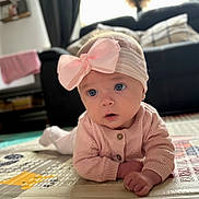 Violet joined the competition — help win amazing prizes! baby, blanket, blue_eyes, child, couch, curious, cute, floor, furniture, headband, indoors, infant, living_room, pink_bow, play_mat, portrait, soft_lighting, sweater, toddler, young_child