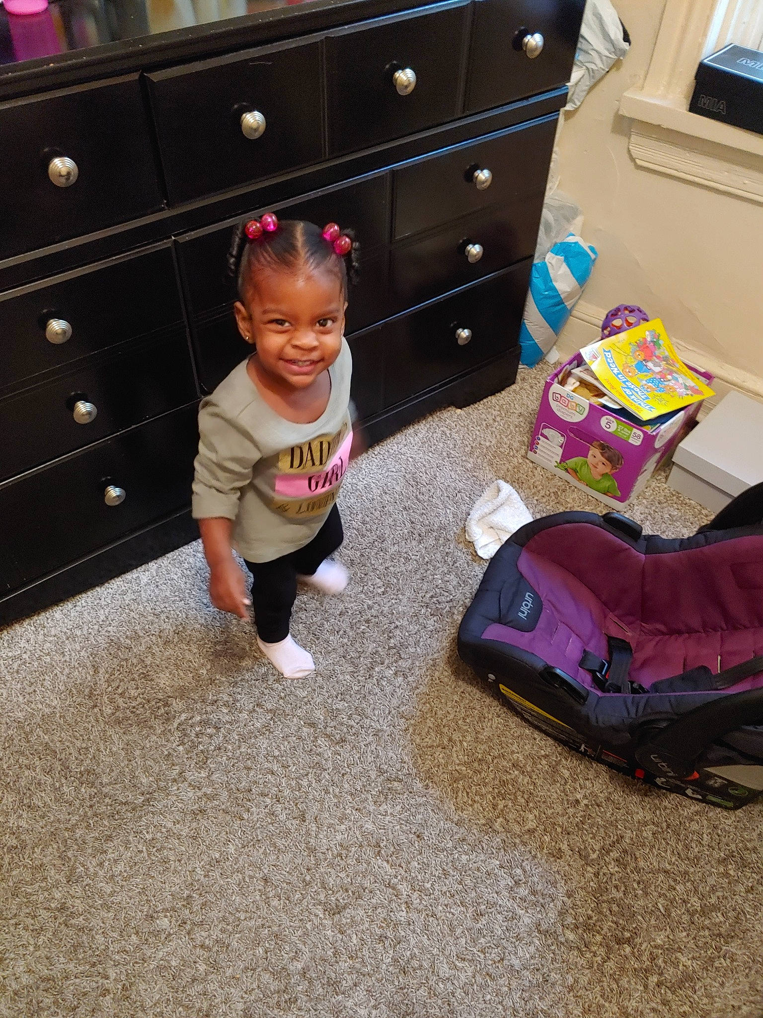 Honesty is registered to the contest to win money with this photo: carpet, chest_of_drawers, child, drawer, floor, flooring, furniture, hardwood, home, joy, living_room, person, play, purple, room, table, toddler