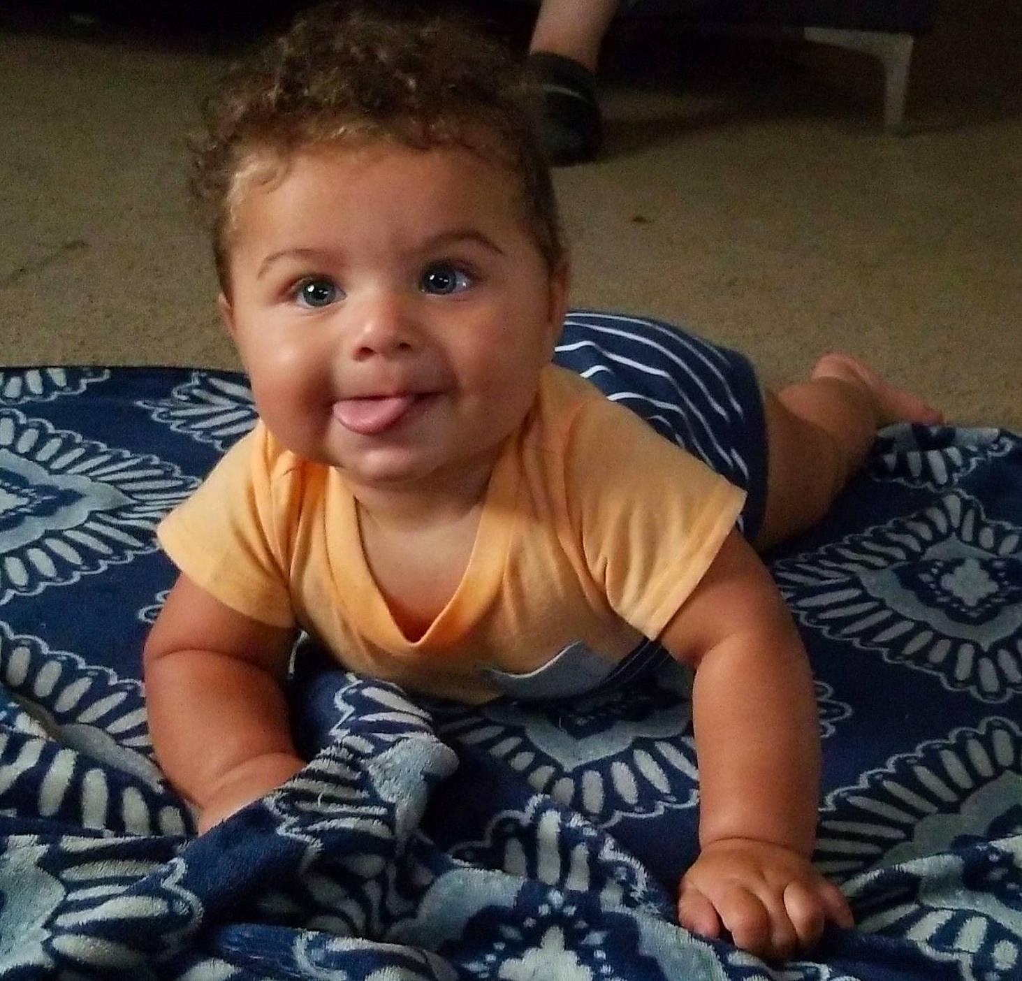 Kaius is registered to the contest to win money with this photo: arm, baby, cheek, child, cool, crawling, eye, face, facial_expression, forehead, fun, hair, head, joy, nose, person, sitting, smile, toddler, tummy_time