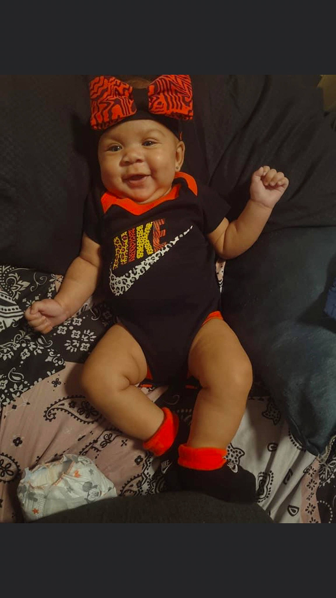 Khalani is registered to the contest to win money with this photo: baby, baby_toddler_clothing, cap, cool, finger, flash_photography, fun, hand, happy, headgear, headwear, human_body, human_leg, mouth, person, personal_protective_equipment, sleeve, smile, sock, t_shirt