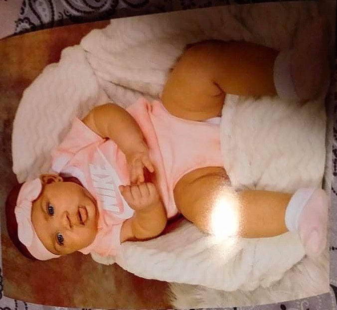 Khalani is registered to the contest to win money with this photo: abdomen, baby, baby_sleeping, baby_toddler_clothing, bed, bedding, bedtime, child, comfort, finger, hand, headwear, human_body, human_leg, linens, nap, person, room, skin, smile