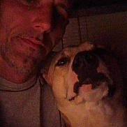 Zelda joined the competition — help win amazing prizes! man, dog, selfie, indoor, low_light, portrait, face, pet, companion, casual, closeup, shadow, human, animal, friendship, expression, head, brown, warm, intimate