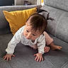 Meï-Linh a rejoint le concours — aidez-le/la à gagner de superbes lots ! baby, child, crawling, pigtails, hair, face, couch, gray_couch, yellow_pillow, cushion, clothing, long_sleeve, indoors, home, person, skin, feet, hands, curious, young
