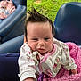 baby, infant, hair, spiky_hair, pink_blanket, white_outfit, chair, blue_chair, grass, hand, cute, child, person, indoors, portrait, reaching_out, pacifier_clip, soft_texture, cozy, expression