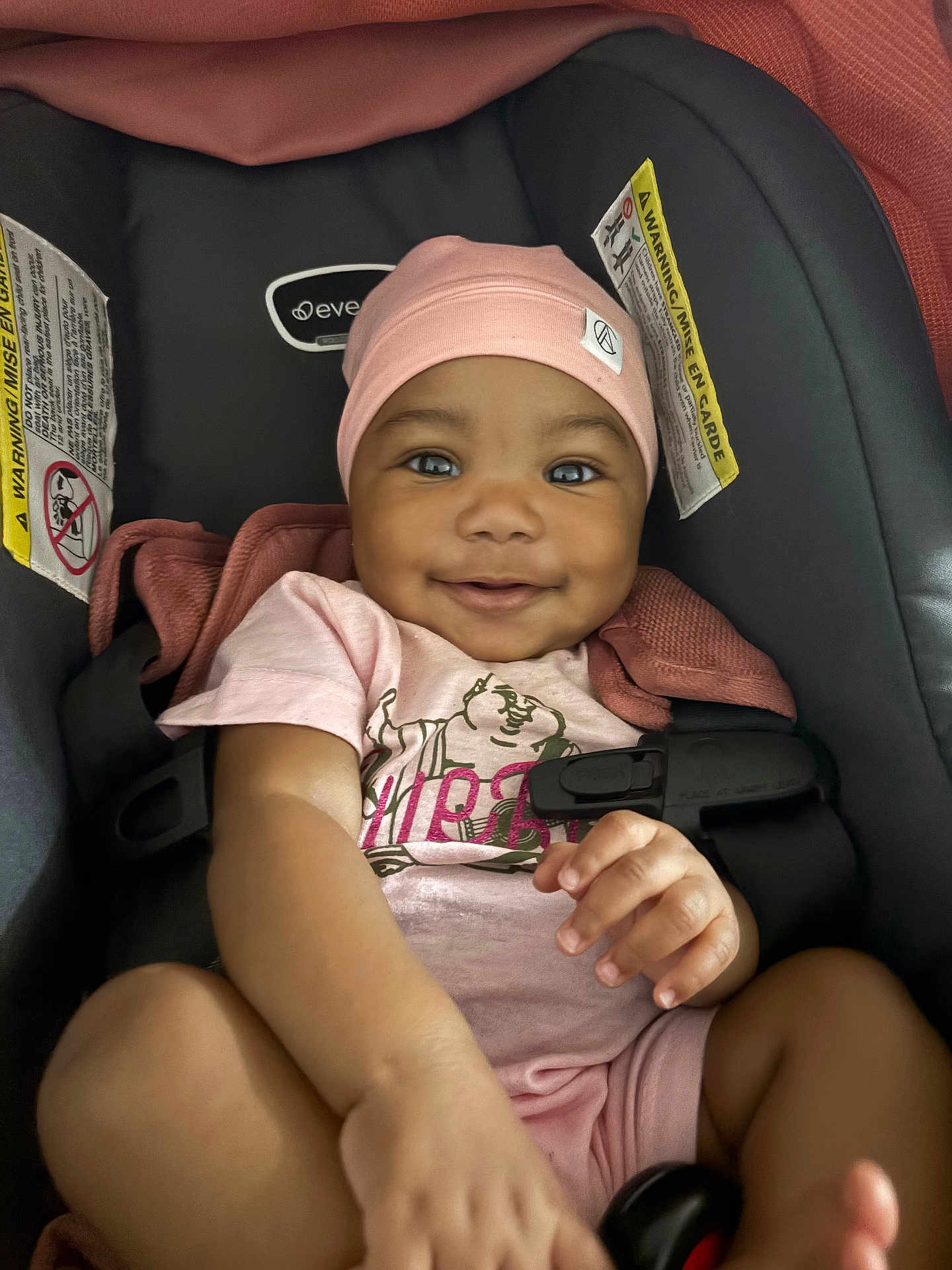 Deoni joined the competition — help win amazing prizes! baby, infant, car_seat, pink_hat, pink_onesie, smiling, happy, child, cute, portrait, indoor, seatbelt, clothing, face, hand, skin, young_child, baby_clothes, closeup, person