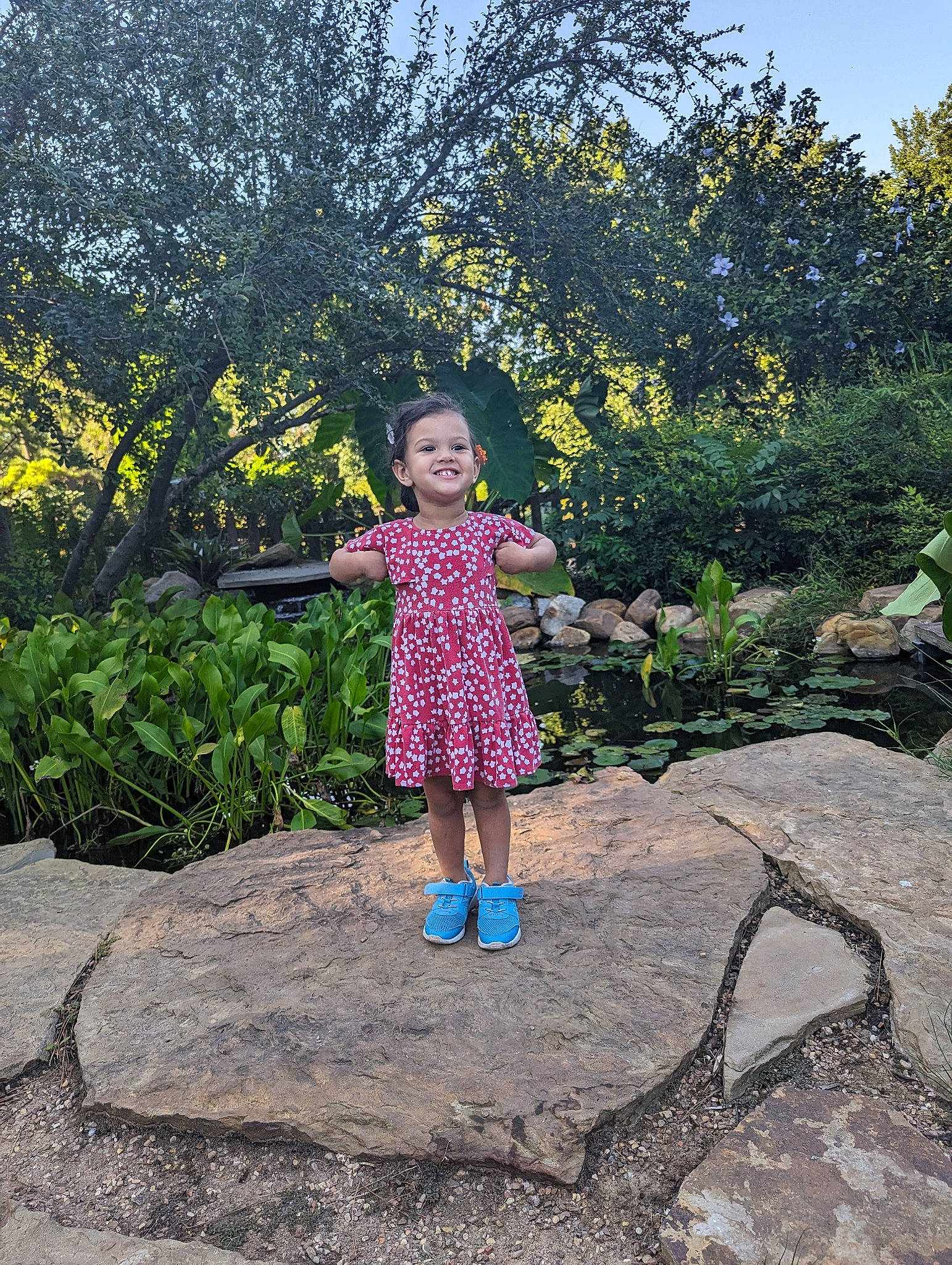 Lorelei is registered to the contest to win money with this photo: child, footwear, fun, garden, grass, grass_family, happy, joy, landscape, leisure, magenta, people_in_nature, person, plant, recreation, road_surface, shrub, sky, soil, toddler